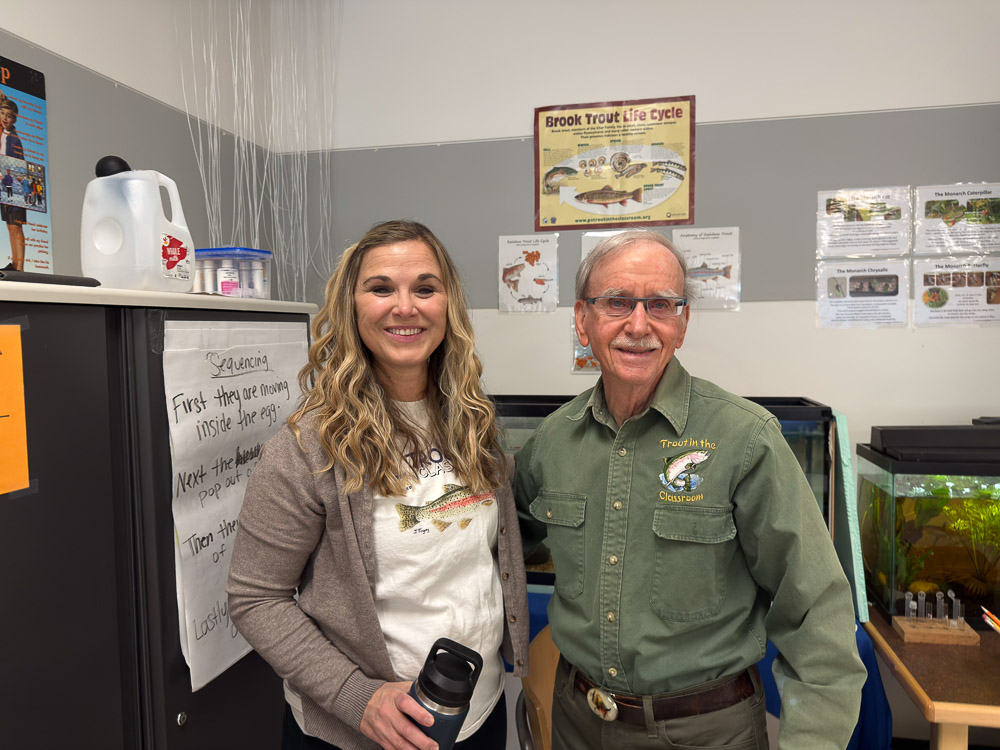 Trout Unlimited volunteer maintaining classroom trout tank
